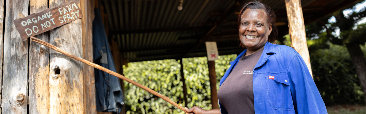 A woman shows a mark with "organic farm" written on it