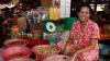 Asian woman at a market. Copyright: Godong